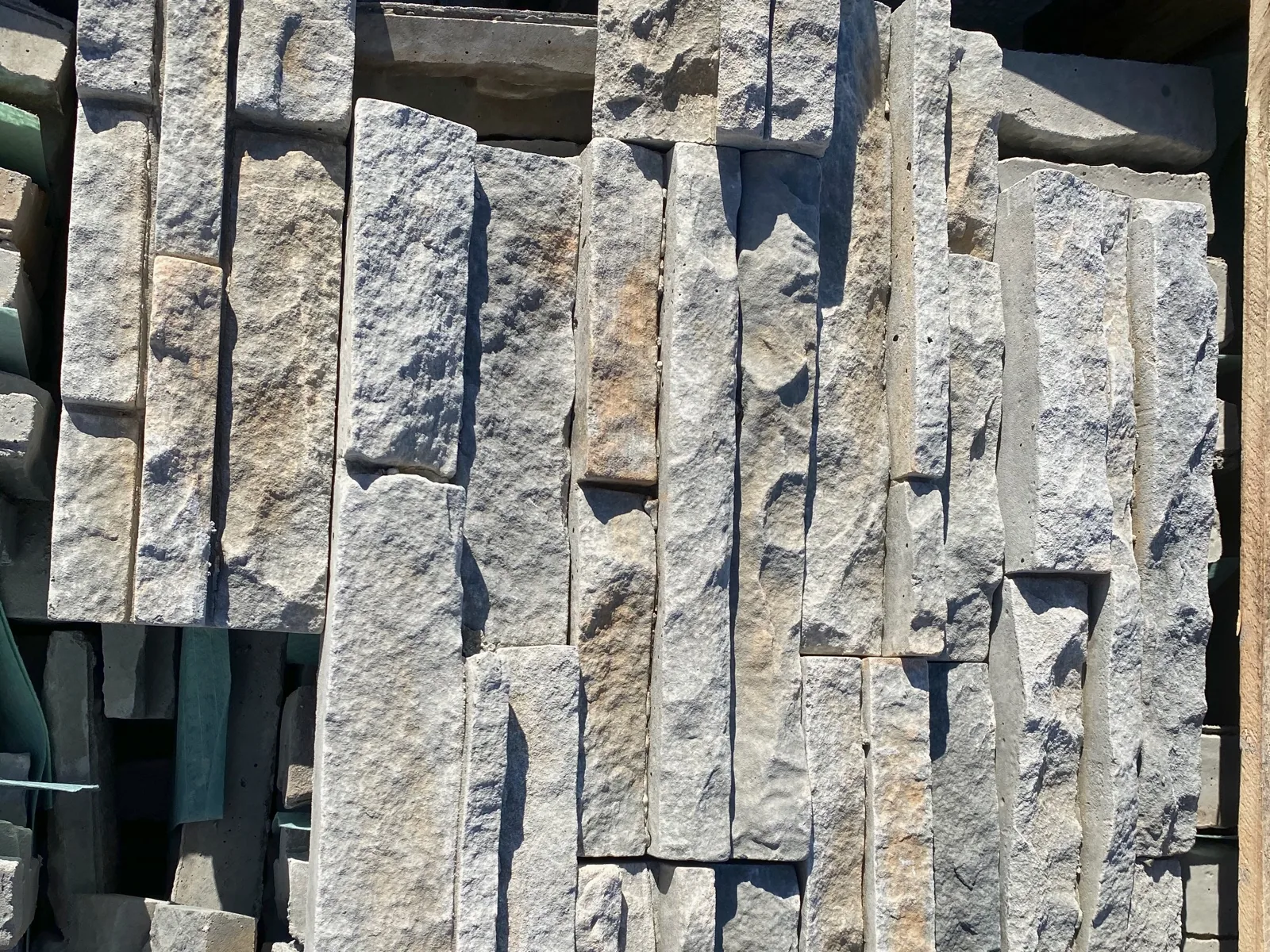 Close view of light gray and beige textured stone samples.