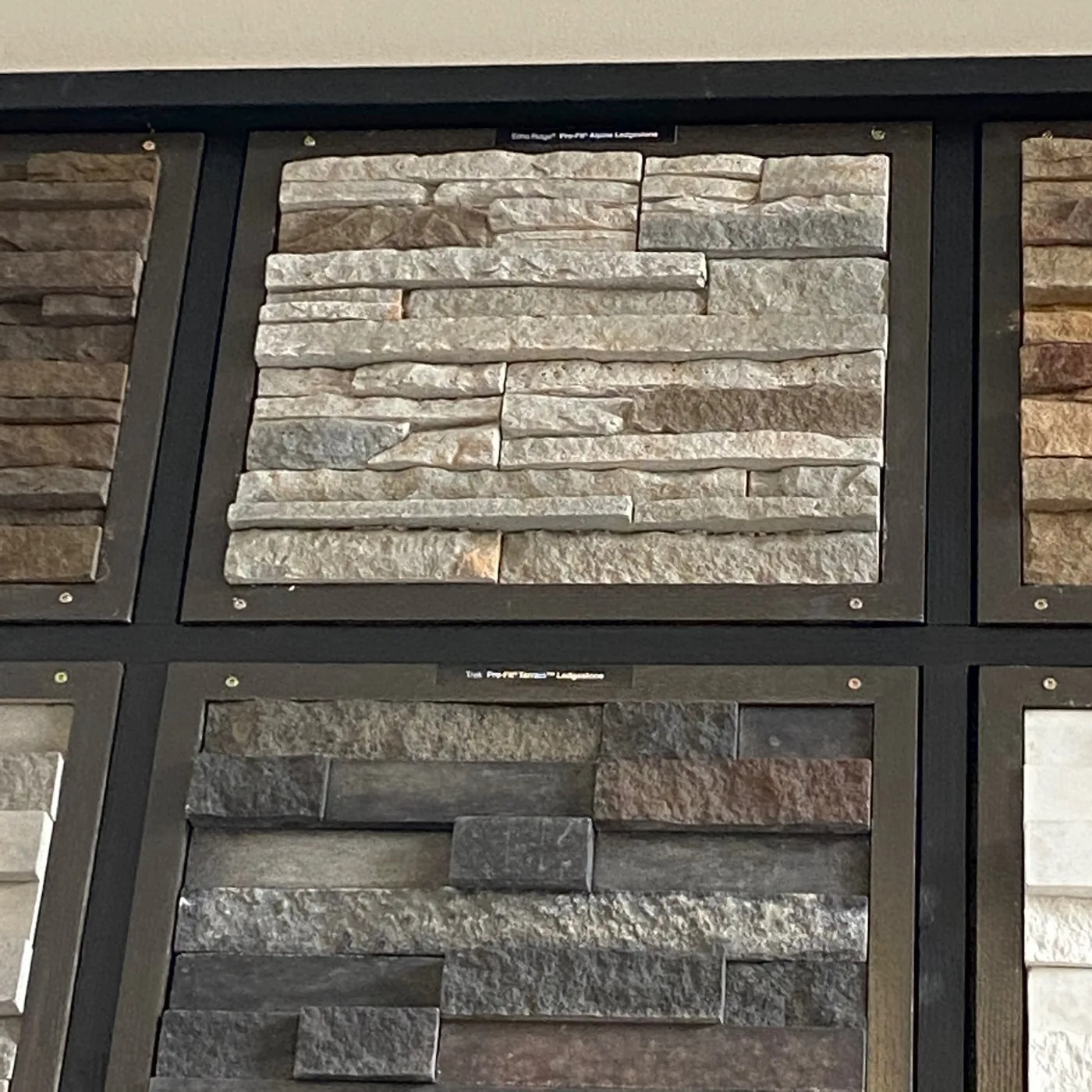 Light and dark stone veneer panels in a showroom display.